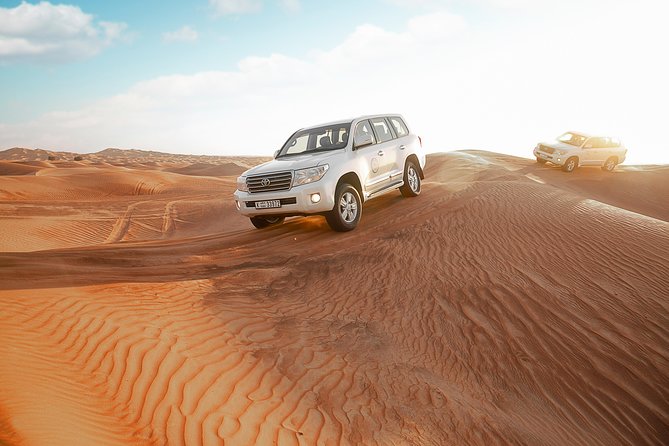 Desert Safari Dubai with Dune Bashing, Sandboarding, Camel Ride, 5 Shows, Dinner - A Bedouin-style camp with tea, henna, and photographs
