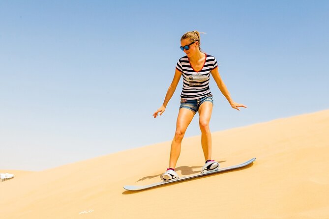 Desert Safari with BBQ Dinner, Camel Ride, Sand Board & Live Show - From Dubai Pickup to the Red Dunes