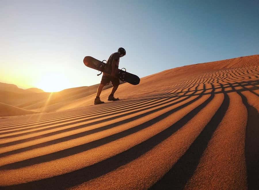 Doha: ATV/Desert Safari with Activities and Inland Sea Stop - Sandboarding down the dunes