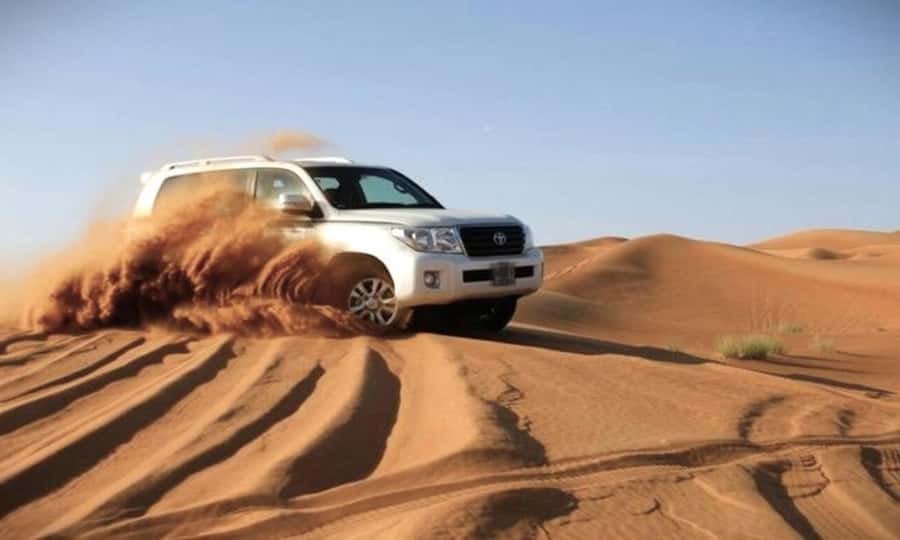 Doha: Desert Safari Dune Bashing, Sandboarding, & Camel Ride - Dune bashing in a 4x4