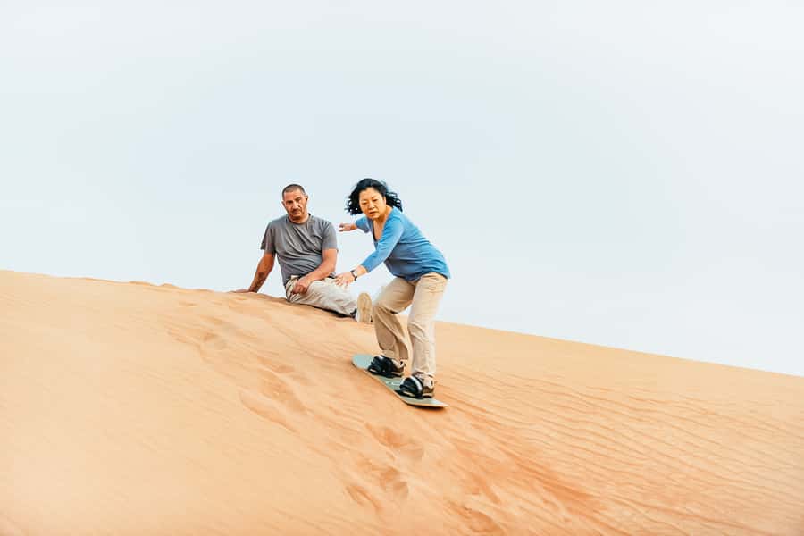 Doha: Desert Safari Dune Bashing, Sandboarding, & Camel Ride - Sandboarding on the high dunes