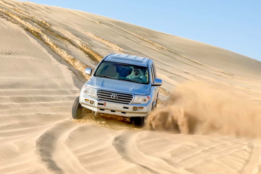 Doha: Half-Day Desert Safari, Quad Bike, Camels & Inland Sea - Sandboarding: simple, funny, and harder than it looks