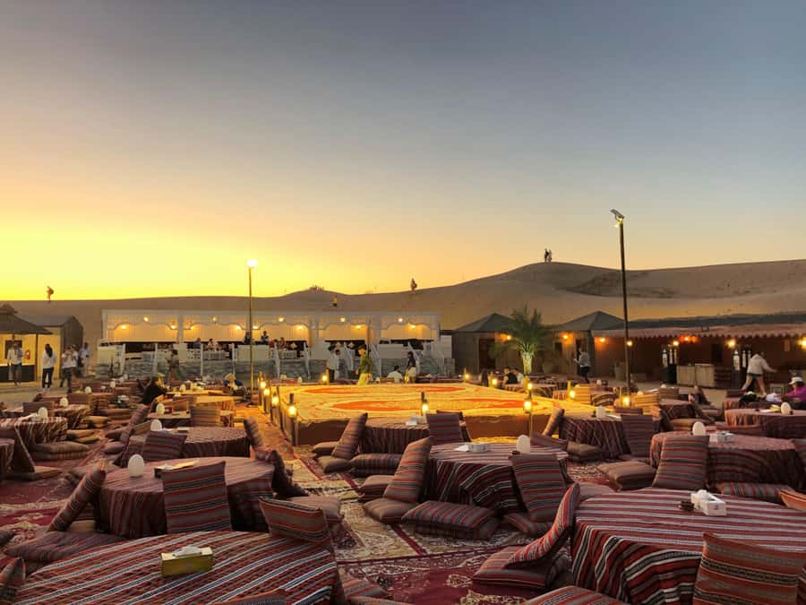 Dubai: Bedouin Camp, Dune Safari, Falcon Show & BBQ Dinner - Sandboarding and sunset above the sand