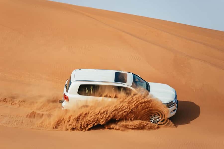 Dubai: Desert Safari, Camel Ride, Sandboarding, Quad Bike - Leaving Dubai for the Red Dunes
