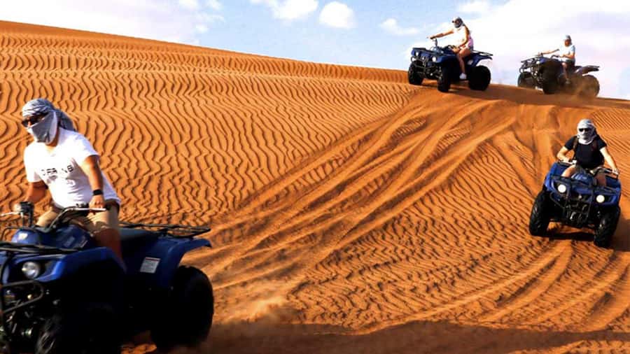 Dubai: Desert Safari, Camel Ride, Sandboarding, Quad Bike - Sandboarding over the dunes