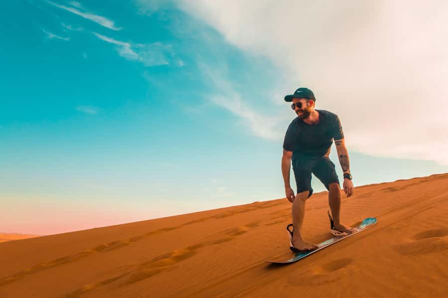 Dubai: Desert Safari, Quad Bike, Sandboarding, Camels & BBQ - Red-dune bashing and sandboarding