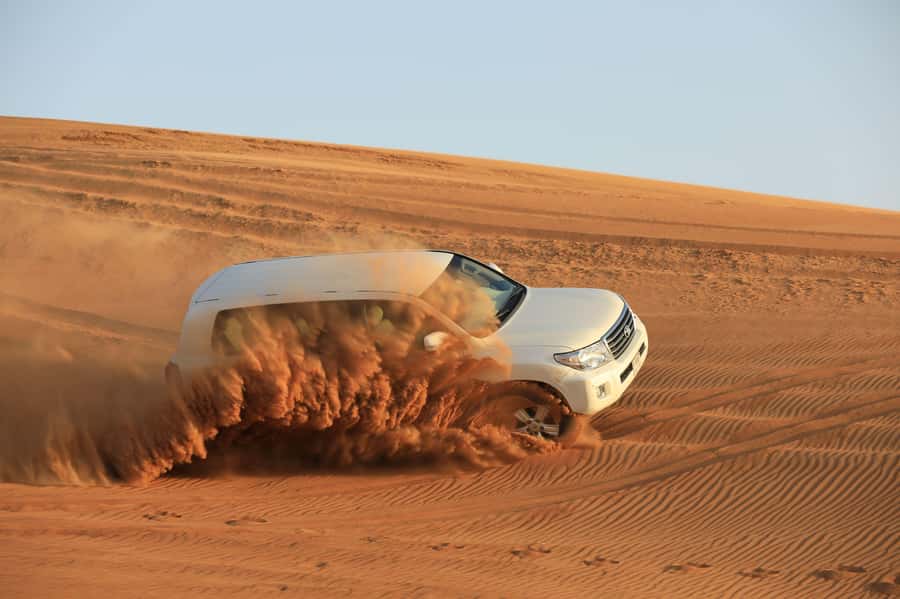 Dubai: Desert Safari, Quad Bike, Sandboarding, Camels & BBQ - Why the guide matters so much