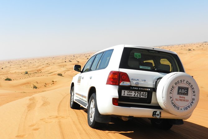 Dubai Desert Safari with BBQ, 3 Shows & Camel Ride at Majlis Camp - Dune bashing in a shared 4x4 SUV