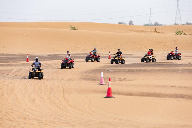 Dubai Desert Safari with Quads, BBQ Dinner, Camel ride, & Shows - Quad biking for ages 13 and above