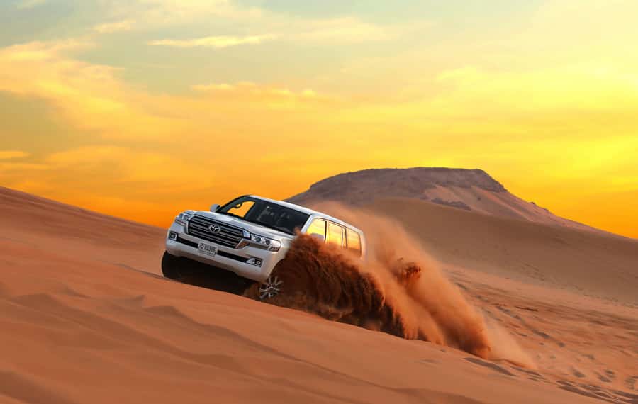 Dubai: Red Dune Desert Safari, Quad Bike, Camels, and BBQ - Sandboarding on the steep red slopes