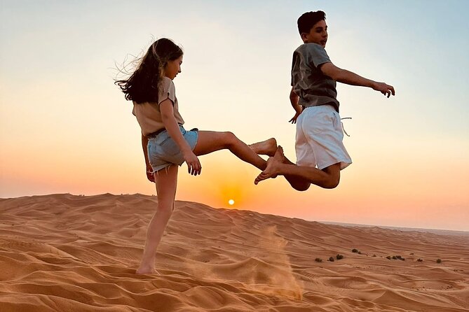 Dubai Red Dune Safari with Bedouin BBQ Dinner & Hotel Transfers - Sandboarding across golden slopes