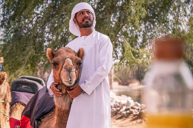 Dubai Red Dunes Safari: Dune Bashing, Camel Ride & Breakfast - Camel riding and sandboarding at the campsite
