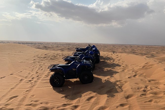 Dubai: Unique SUNSET Quad Bike Red Dunes Safari - Pickup, timing, and the extra charges