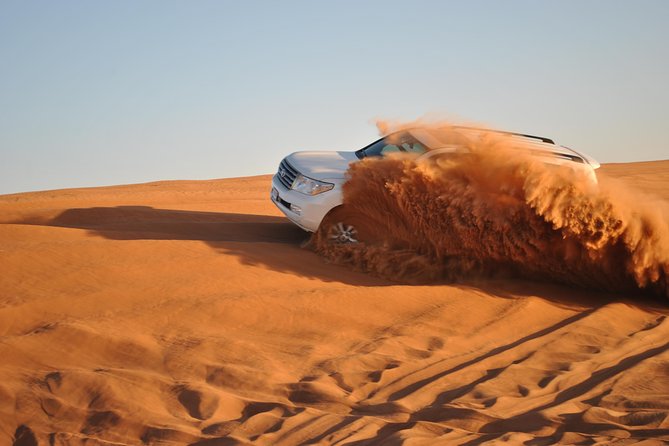 Half Day Desert Safari || Sand Boarding || Camel Ride || Inland Sea Visit || - Sandboarding across the soft slopes