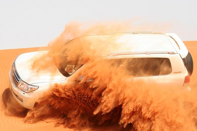 Morning Dubai Desert Safari with Sand boarding and Camel Ride - Sandboarding from the top of a dune