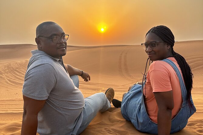 Sunset Desert safari with Camel Ride Sand Board & BBQ Dinner - Pickup, timing, and group size